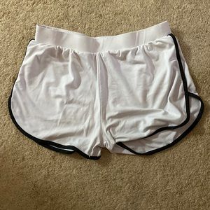 Medium white AQ-Sport shorts with black lining.